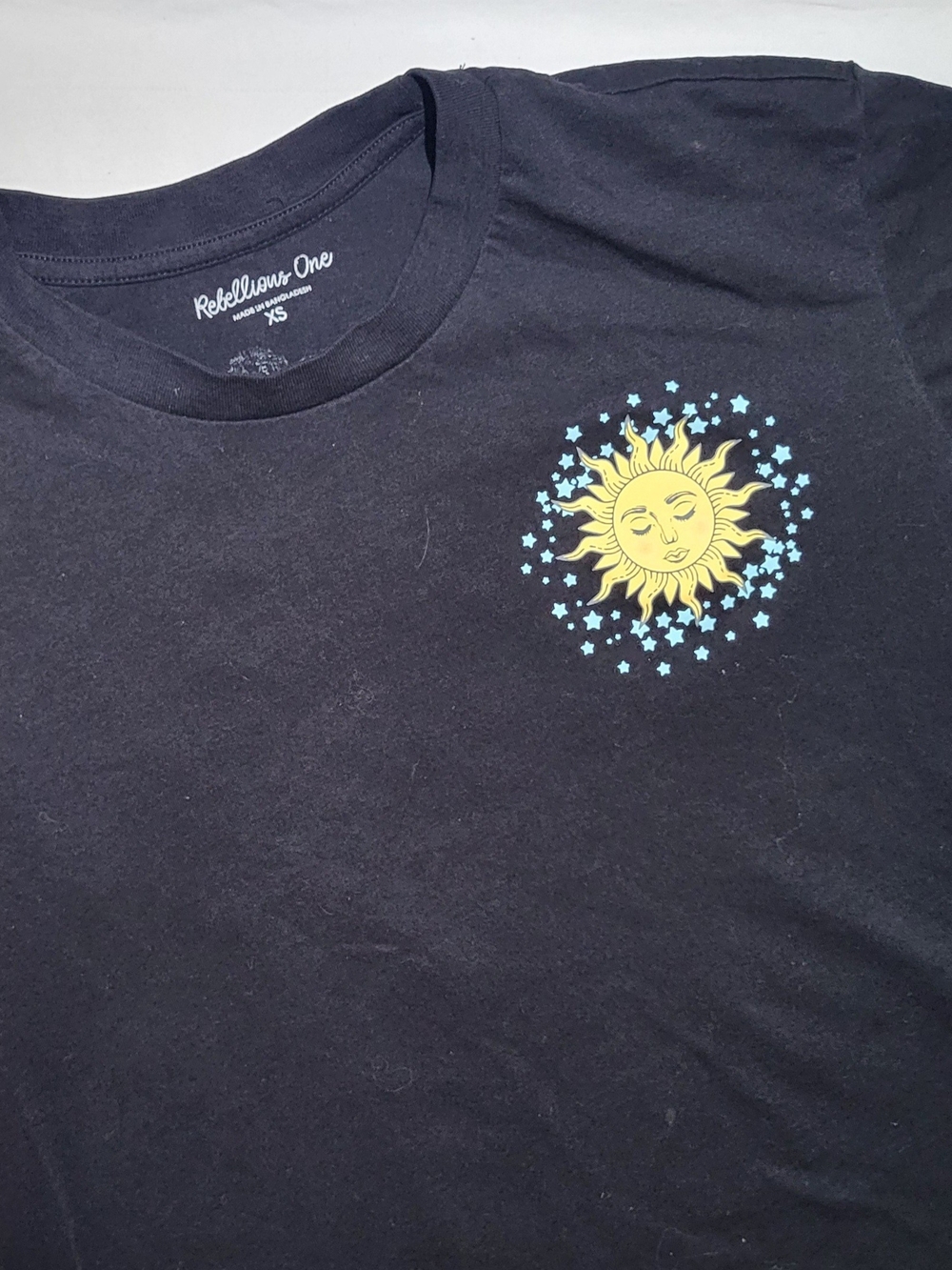 Rebellious One Black Tee with Yellow Sun and Light Blue Stars